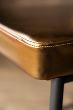Burnished Gold Roll Back Bar Stool